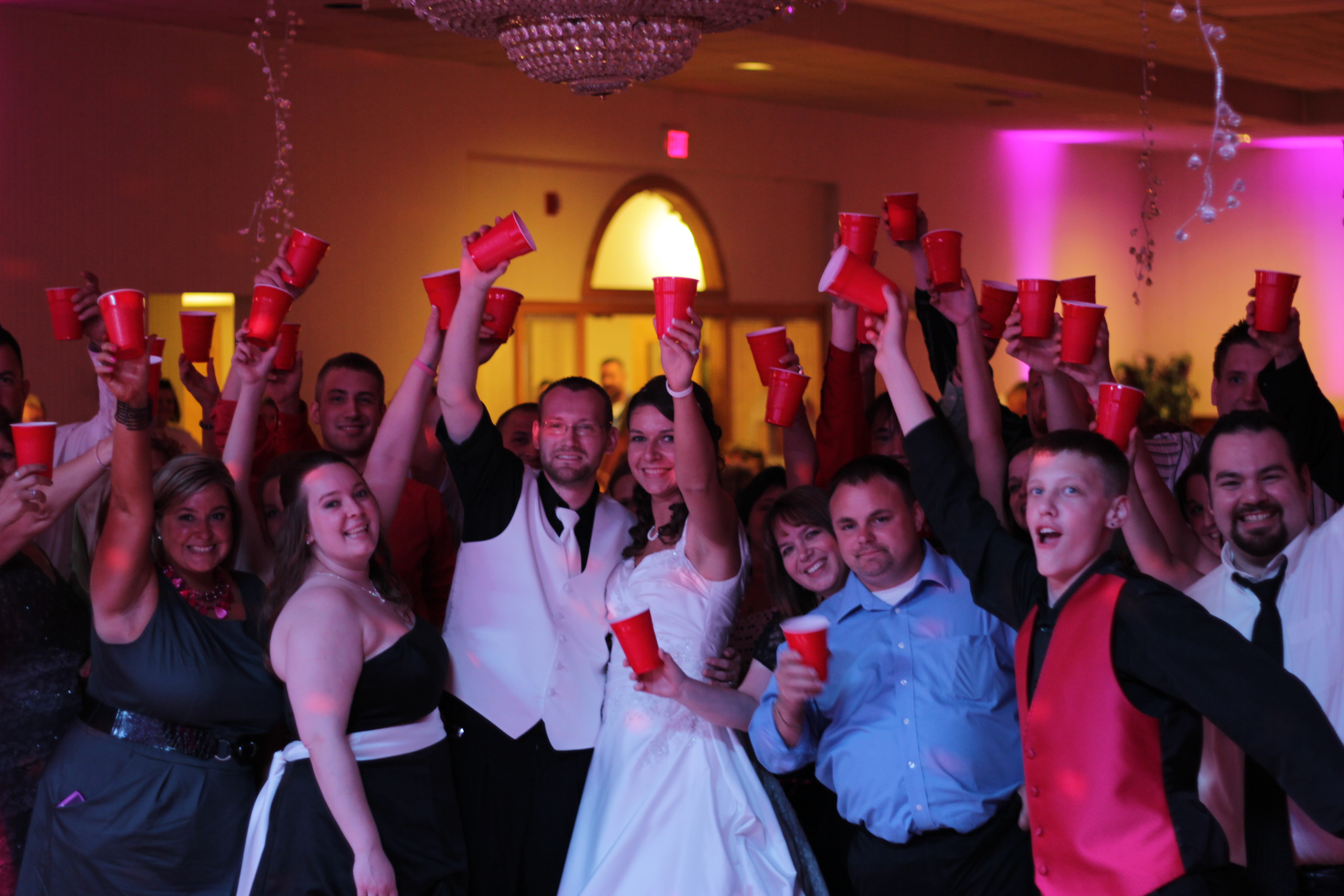 Guests dancing at Cleveland wedding with purple lighting
